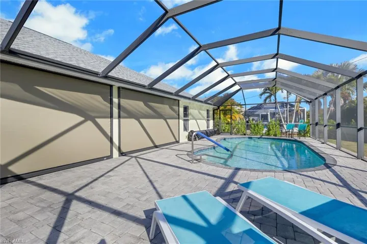 Outdoor pool with a sunroom, a lanai, and a patio
