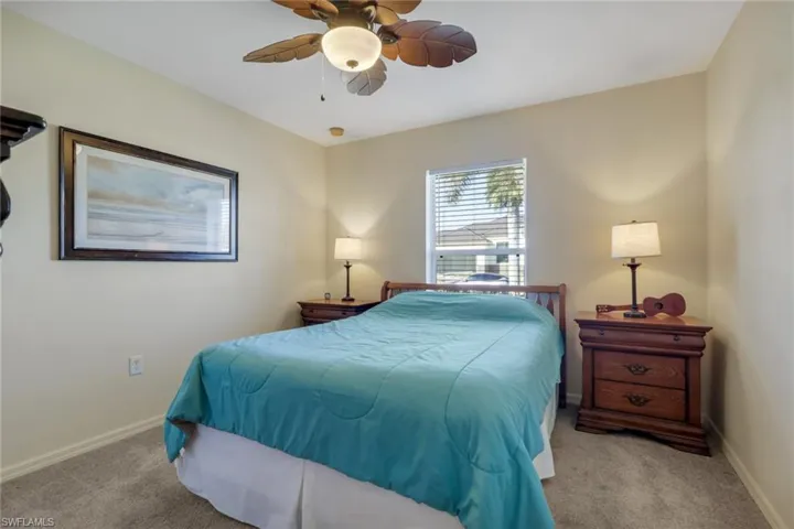 Bedroom with a ceiling fan and carpet flooring