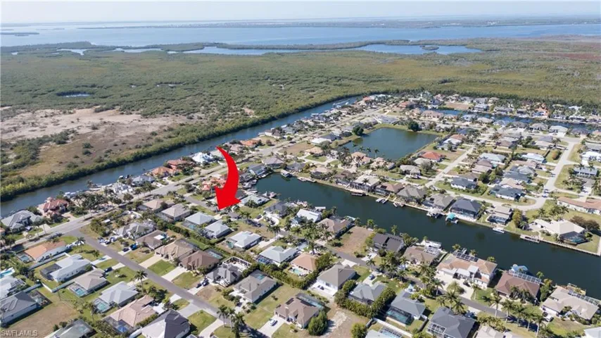 View of property location featuring a large body of water and nearby suburban area
