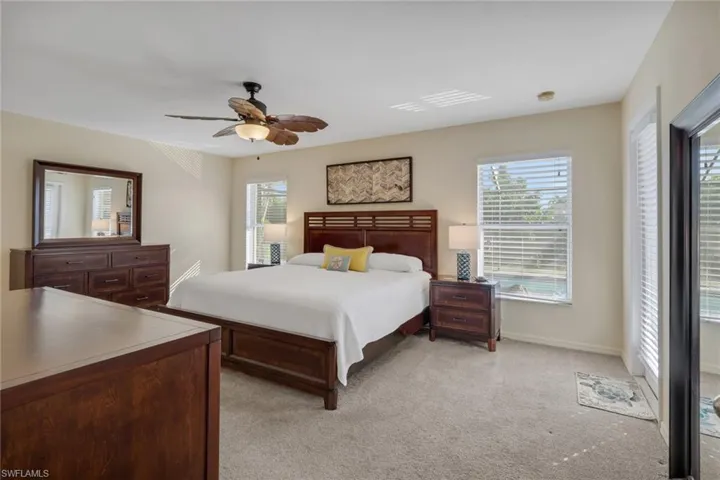 Bedroom featuring light colored carpet and a ceiling fan