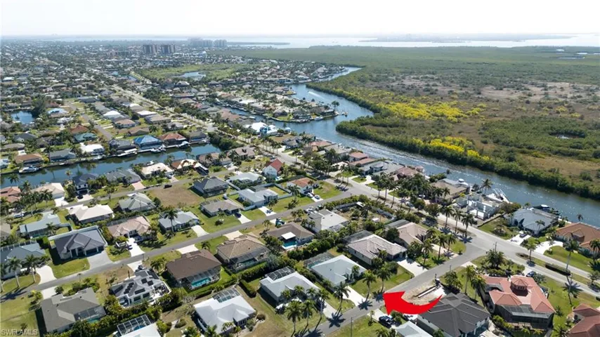 Aerial overview of property's location featuring a nearby body of water and nearby suburban area