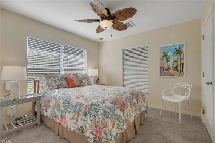 Bedroom with light colored carpet and ceiling fan