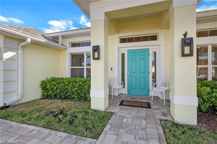 Property entrance featuring stucco siding