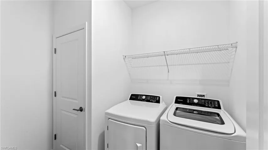 Laundry area with washing machine and clothes dryer