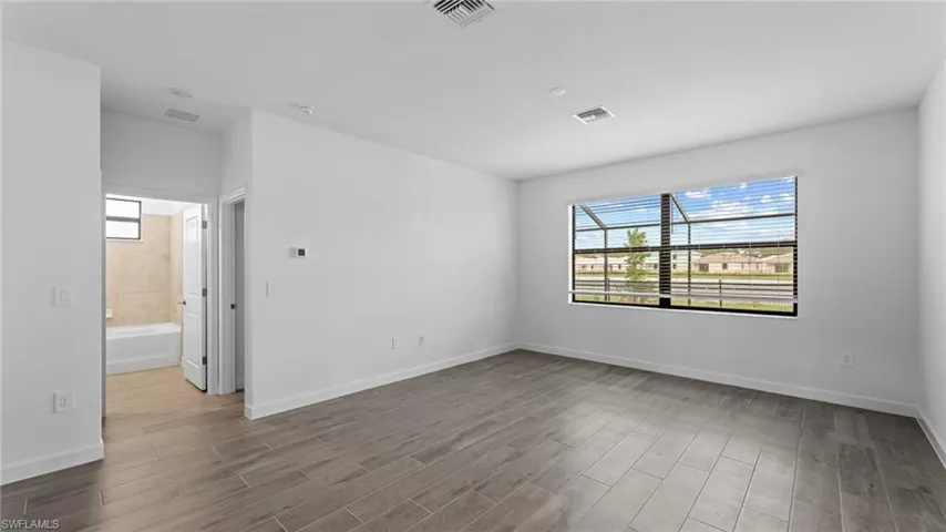 Unfurnished room with hardwood / wood-style floors