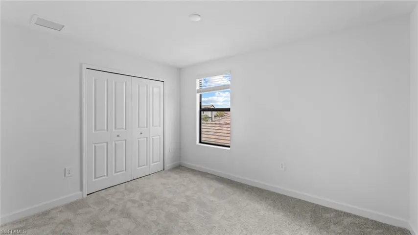Unfurnished bedroom with carpet flooring and a closet