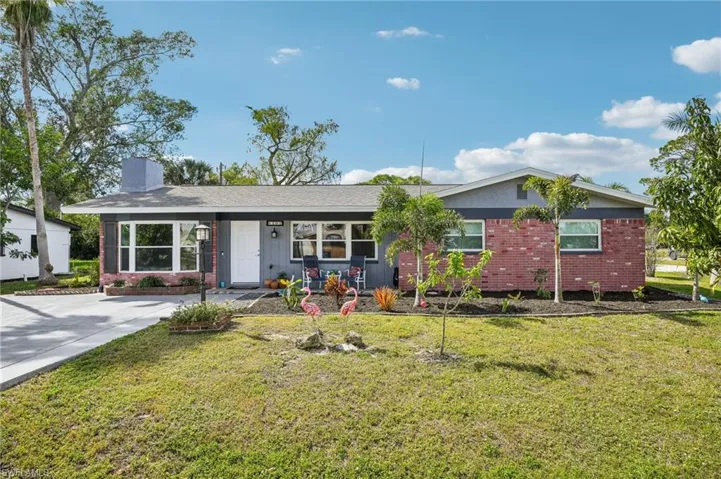 Single story home featuring a landscaped front yard