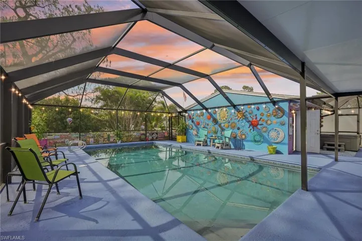 Outdoor Oasis with pool, screen enclosure and a patio with Key West Vibe