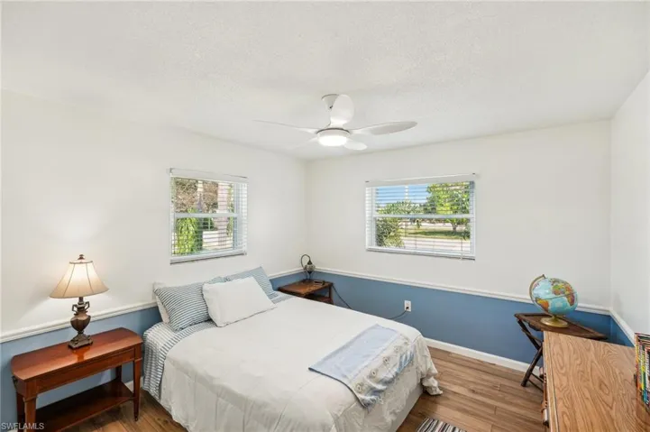 Bedroom 3 with a ceiling fan and light wood  laminate floors