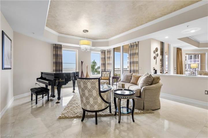 One of two living areas in the home all with views of the river and wildlife. Tray ceilings, custom lighting, 24 x 24 porcelain tile.