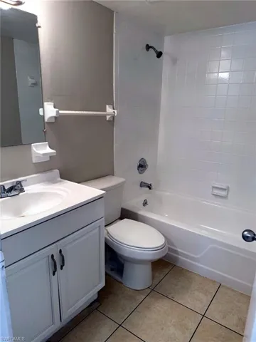 Bathroom featuring a white vanity with integrated sink, chrome faucet, and storage cabinetry