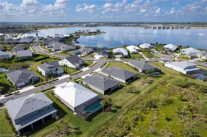 Birds eye view of property with a water view