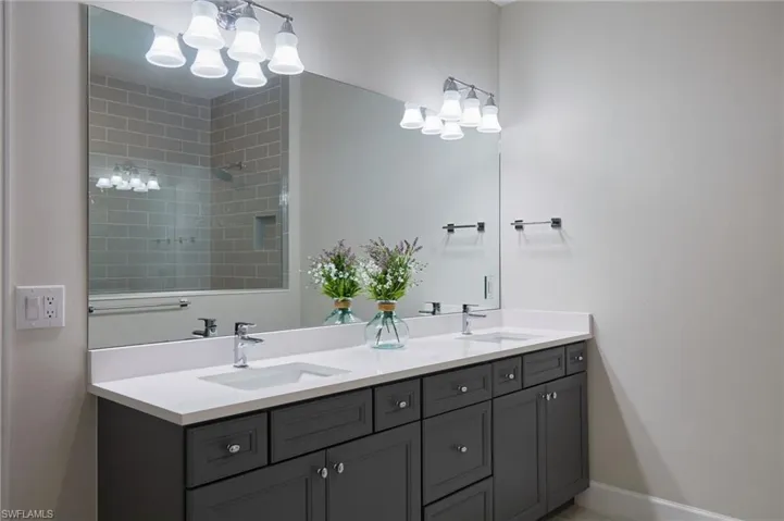 Bathroom with vanity and a notable chandelier