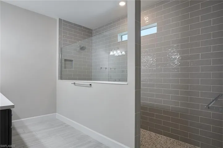 Bathroom with vanity and a tile shower