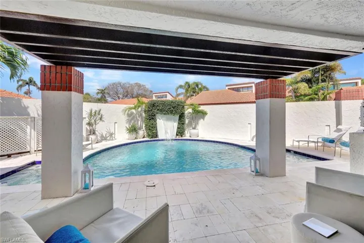 View of swimming pool with pool water feature and a patio area