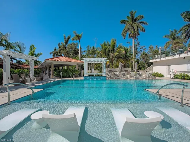 Community pool featuring a pergola and a patio