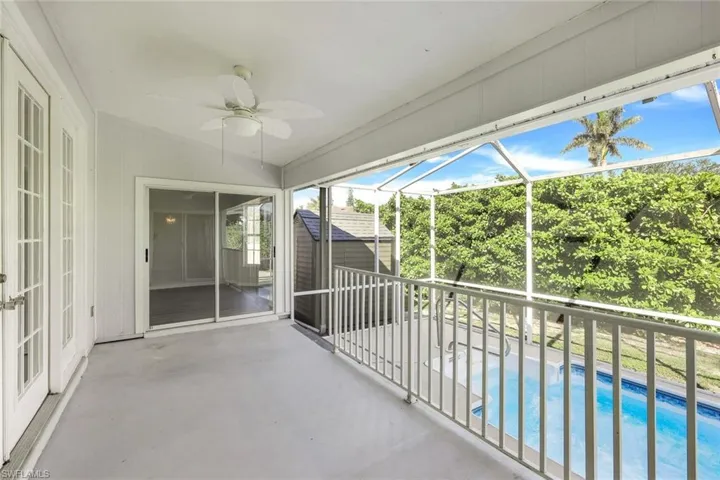 View of pool with a lanai and a patio area