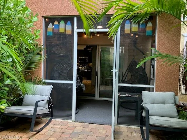 View of exterior entry featuring a patio area and stucco siding