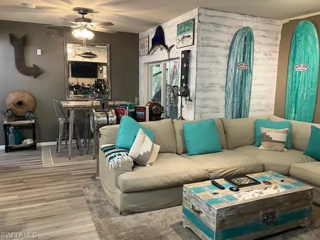 Living area with wood finished floors and a ceiling fan