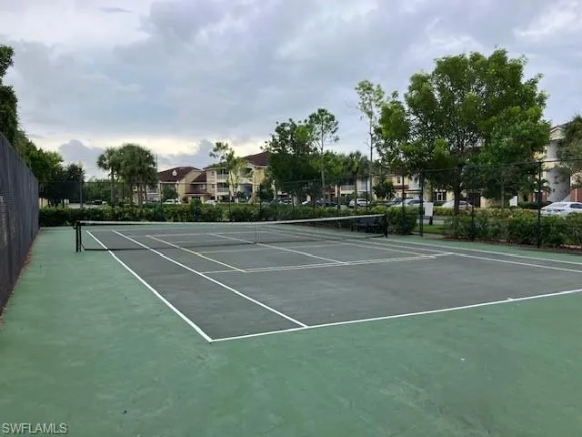 View of tennis court with community basketball court and a residential view
