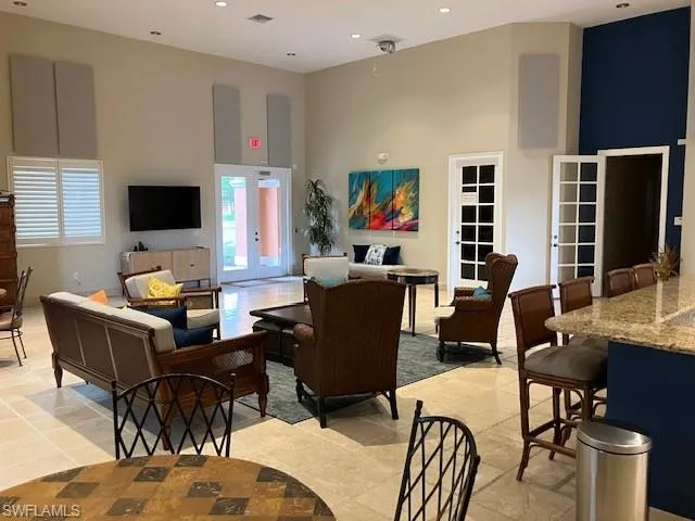 Living room with a high ceiling and recessed lighting