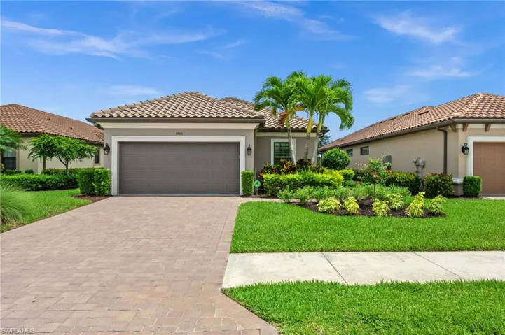 Mediterranean-inspired exterior with a tile roof and stucco siding