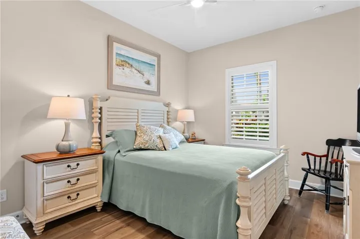 Spacious room featuring wood-finish flooring and a ceiling fan