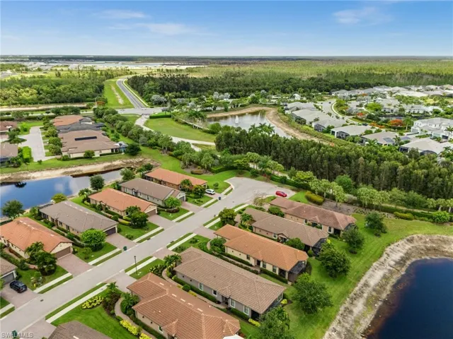 Aerial perspective showcasing a residential community with water features