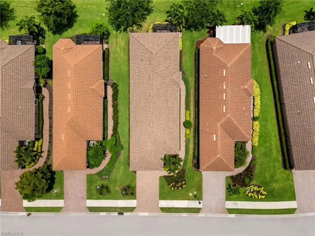 Aerial perspective showcasing three residential properties with terracotta-style tile roofs