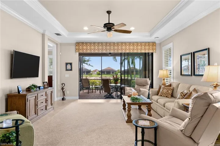 Living room featuring a large screened lanai with outdoor seating and water views