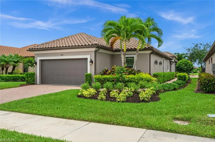 Mediterranean-style residence featuring a tile roof and stucco exterior