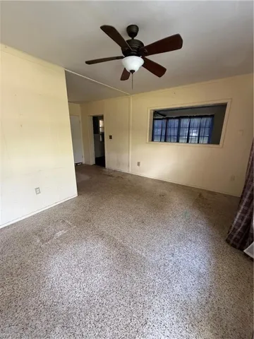 Unfurnished room with a ceiling fan and speckled floor