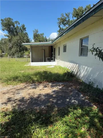 View of yard with a sunroom
