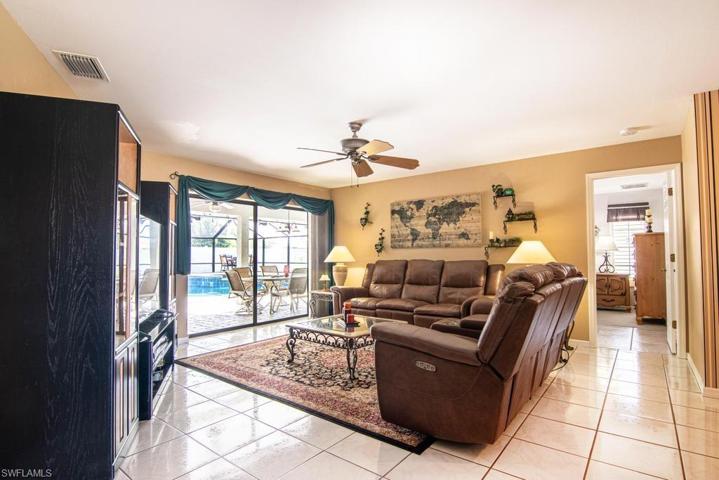 Living Room with a view of the pool. Door to Master Suite in the background (right).