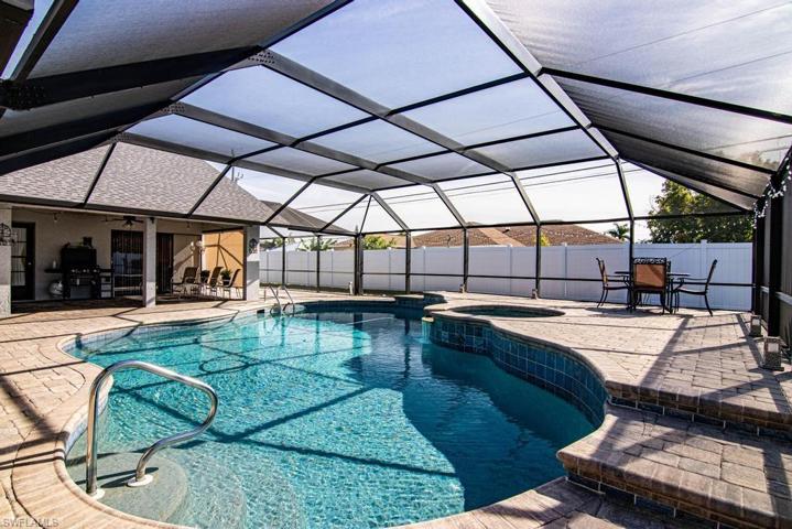 Large free form propane heated pool with a spa.