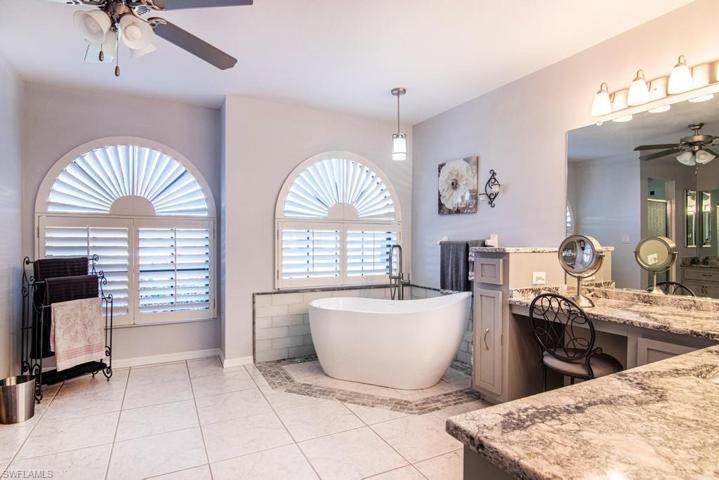 Master Bathroom with his and hers vanities, separate tub and walk-in shower.