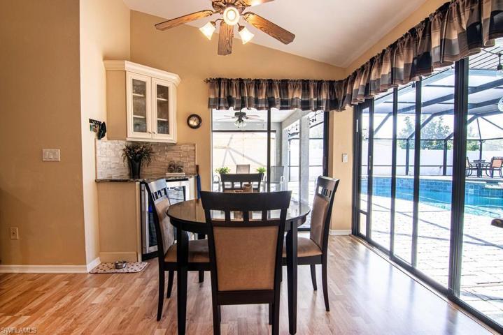 Breakfast Nook with a wine refrigerator/bar area and view of the pool.