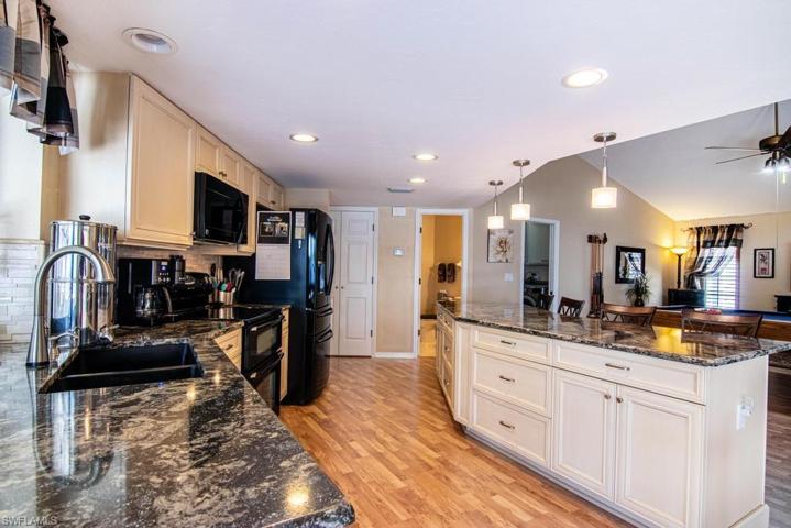 Kitchen with Walk-In Pantry Closet Door and Half Bathroom in center background.