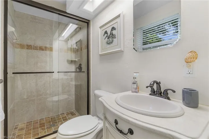 Full bath with vanity and a stall shower