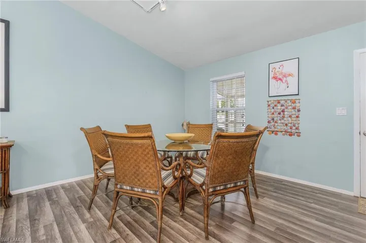 Dining room with wood finished floors and vaulted ceiling