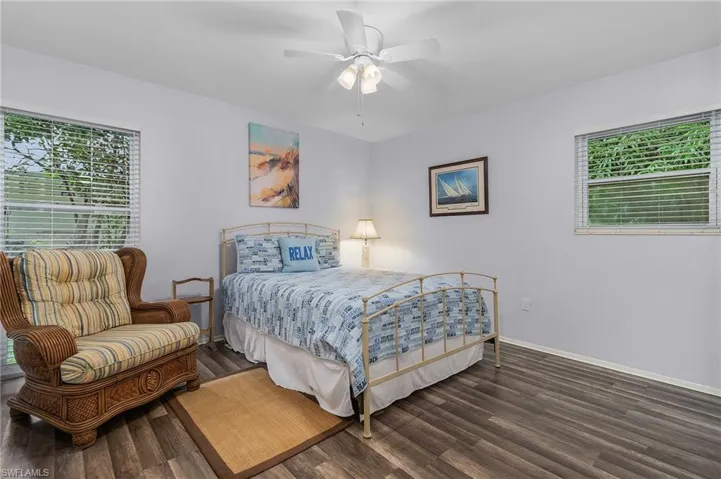 Bedroom with multiple windows, wood finished floors, and a ceiling fan