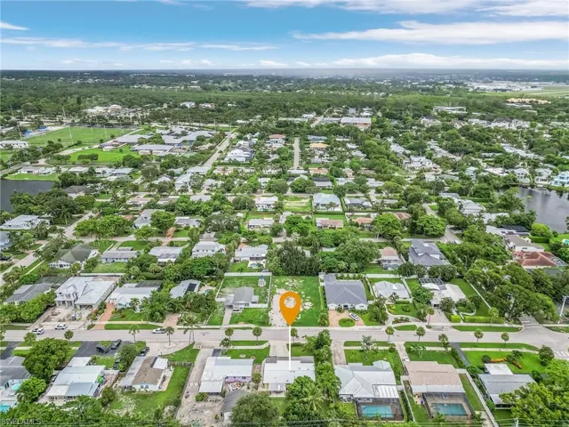 Aerial overview of property's location featuring nearby suburban area and a large body of water
