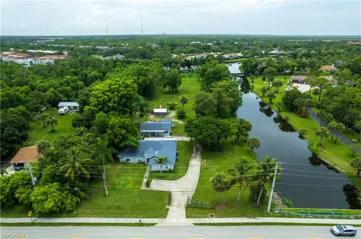Birds eye view of property with a water view