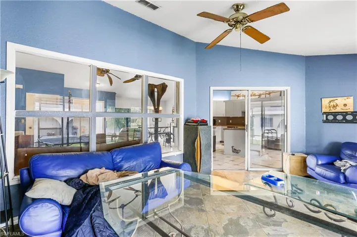 Tiled living room featuring ceiling fan