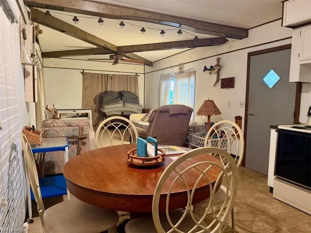Dining space featuring beam ceiling, healthy amount of natural light, and ceiling fan