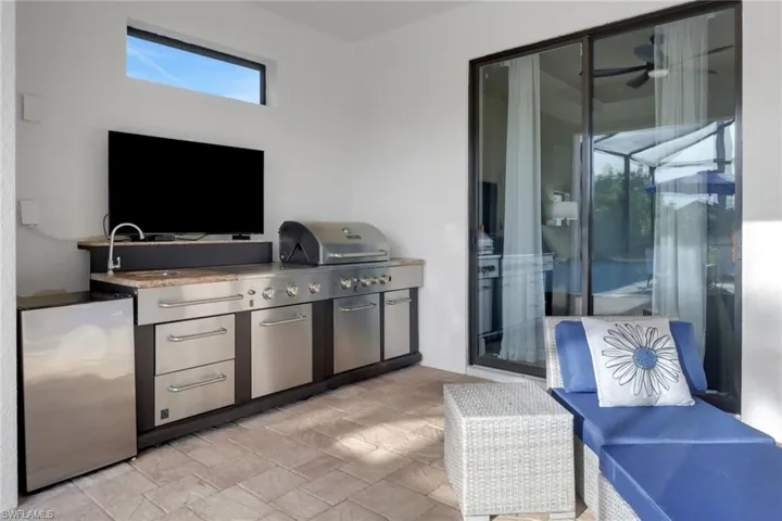 View of patio featuring an outdoor kitchen and a sink