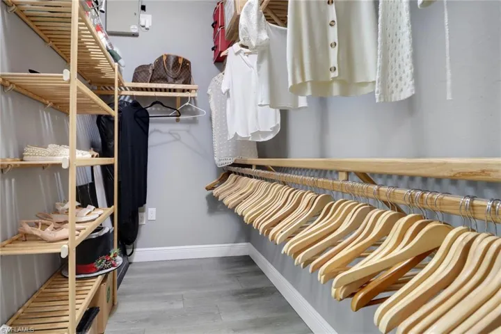 Walk in closet featuring light wood-style flooring