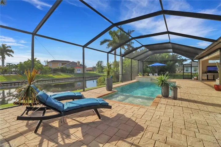 Swimming pool with a sunroom, a lanai, and a patio area