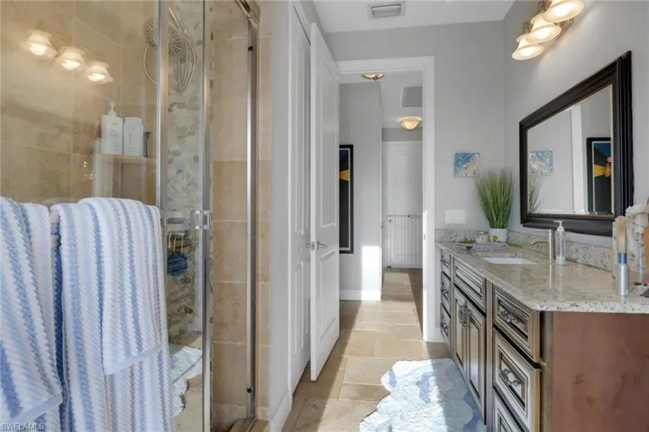 Full bath featuring vanity and a shower stall