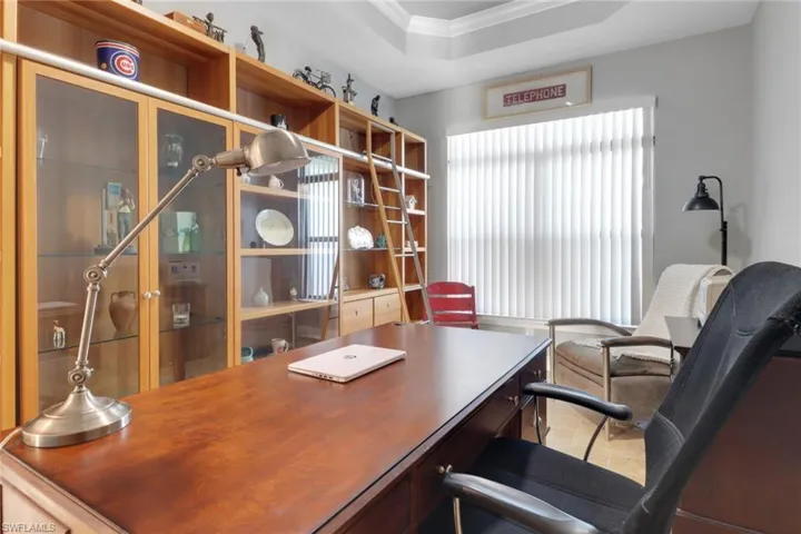 Office featuring crown molding and a tray ceiling